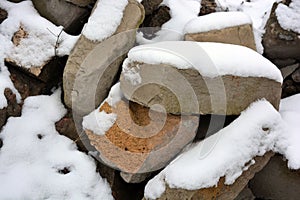 A mountain of building materials, bricks, cement blocks, pieces of metal fittings with gray cecent cobbles, rubbish, rubbish cover