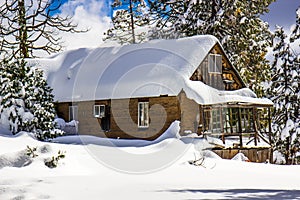 Mountain cabin with snow covered roof