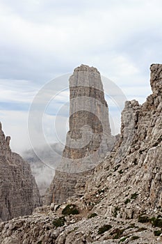 Mountain Campanile Basso in Brenta Dolomites with clouds, Italy