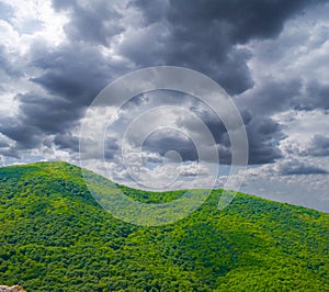 mountain chain under a dense cloudy sky