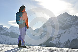 Mountain climber climbing at a snowy ridge photo