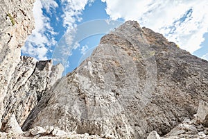 Mountain climber rappelling down cliff