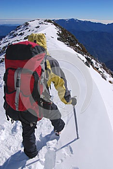 Mountain climber on snowy summit