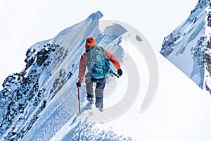 Mountain climber on a steep narrow snow ridge, extreme alpinist mountaineer, Monch, Bernese Alps, Swiss