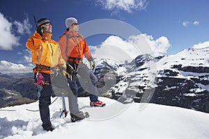 Mountain Climber Using Walkie Talkie By Friend On Snowy Peak photo