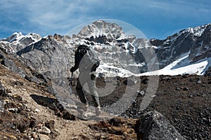 Mountain Climber walking up along sharp Ridge