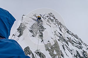 Mountain climbers climbing the snow covered Alps in Mont Blanc Massif