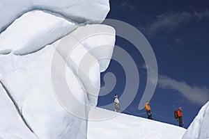 Mountain Climbers Walking Past Ice Formation