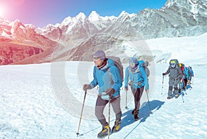 Mountain Climbers walking up on Glacier in weather protective Clothing