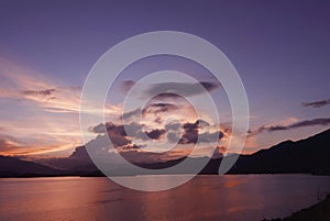 Mountain, cloudscape, dramatic sky and ocean at sunset