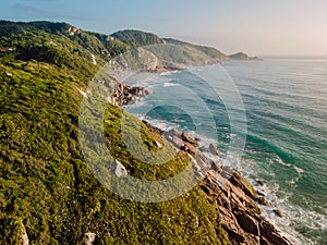 Mountain coastline with ocean at soft sunrise in Brazil, Florianopolis. Aerial view photo