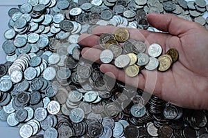 Mountain coins and coins in hand.
