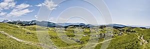 Mountain cottage hut or house on hill Velika Planina alpine meadow landscape. Eco farming. Kamnik Alps, Slovenia. Big Plateau. Pan