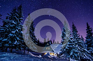 Mountain cottage . Milky Way Galaxy. Purple night sky stars above mountains