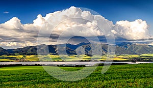 Mountain country landscape with rainy clouds on the sky