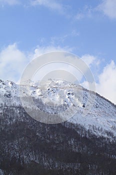 Mountain covered by snow background in blue sky