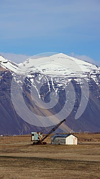 Mountain and crane near Hofn in east fjords in Iceland photo