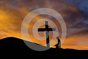 A mountain cross and a worshiper photo