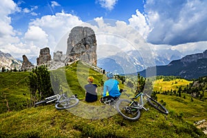 Mountain cycling couple with bikes on track.