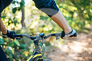 Mountain  cyclists grasp the bike handle, focus on gloves