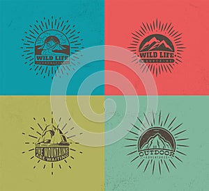 Mountain emblems. Set of four vector colored vintage badges, mountaineering camp and tourism, hiking expedition labels