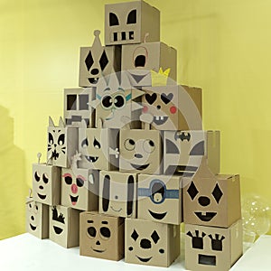 A mountain of emoticons carved from cardboard boxes. Funny, sad, angry and gullible