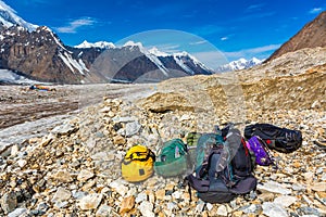 Mountain Expedition Luggage on Rocky Moraine of Glacier