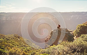 Mountain explorer taking in views from a rock precipice