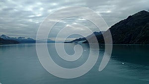 Mountain Filled horizon on the pacific ocean. Inside passage Alaska under a cloudy sky