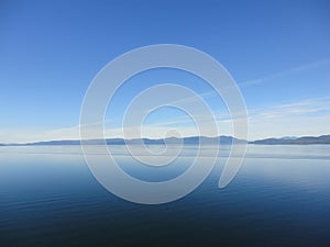 Mountain Filled horizon on the pacific ocean. Inside passage Alaska under a cloudy sky