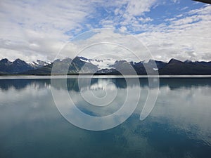 Mountain Filled horizon on the pacific ocean. Inside passage Alaska under a cloudy sky