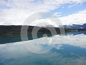 Mountain Filled horizon on the pacific ocean. Inside passage Alaska under a cloudy sky