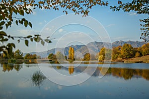 Mountain with forets with lake under sky.