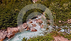 Mountain fresh and cold river in summer time under cloudy sunny blue sky