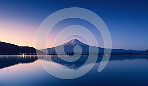 Mountain Fuji at dawn with peaceful lake reflection