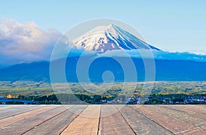 Mountain fuji at morning in Japan and empty wood desk .Blank space for text and images