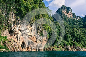Mountain full of green tree and cliff.