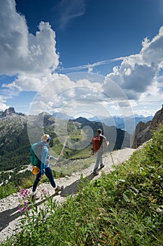 Mountain guide and blonde woman client returning from a climb in the Italian Dolomites