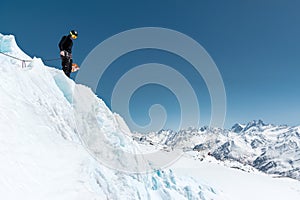 Mountain guide candidate training ice axe and rope skills on a glacier in the North Caucasus