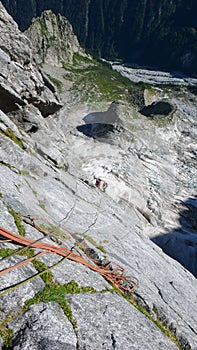 Mountain guide on a hard granite climb to a high alpine peak in the Swiss Alps