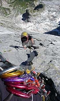 Mountain guide on a hard granite climb to a high alpine peak in the Swiss Alps