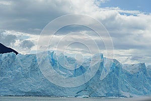 A mountain guide helps ice trekking tourists on Perito Moreno Glacier in the Los Glaciares National Park