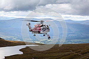 Mountain helicopter rescue action by coastguard on Ben Nevis, Scotland,Fort William, Scotland, UK