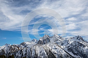 Mountain high ridge in the snow during the day in sunny weather