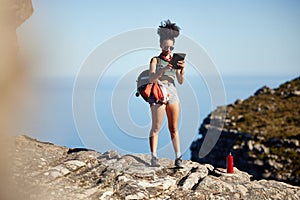 Mountain, hiking and backpack of woman with tablet for travel guide, networking or fitness blog update. Black person