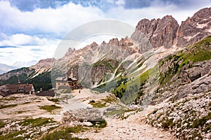 Mountain hiking trail with people walking in Dolomite alps