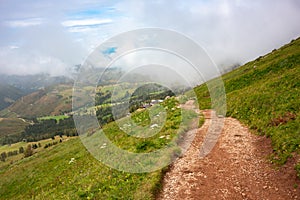 Mountain hiking trail with people walking in Dolomite alps