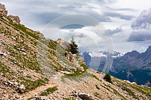 Mountain hiking trail with people walking in Dolomite alps