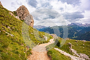 Mountain hiking trail with people walking in Dolomite alps