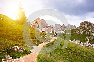 Mountain hiking trail with people walking in Dolomite alps